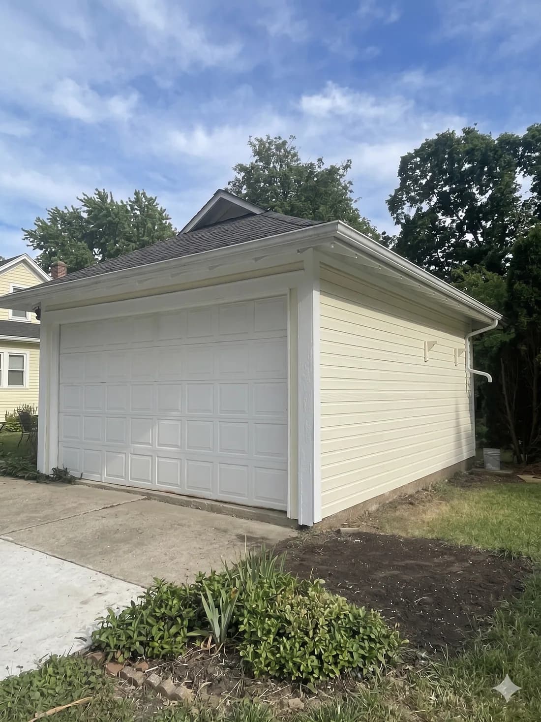 Detached garage repaint with clean siding lines